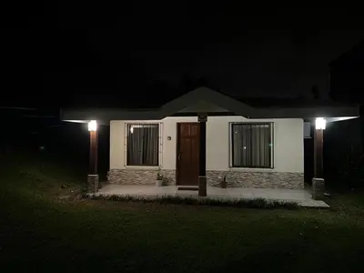 a small house with two lights in the dark at Casa de Campo Nara in Fortuna