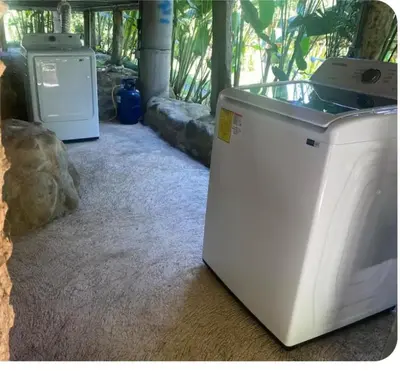 a white washing machine sitting in a room at Cabaña nido de amor escondida en la naturaleza in San Francisco