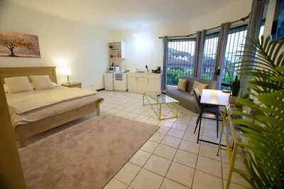 a bedroom with a bed and a couch and a table at Galeon House in San Rafael