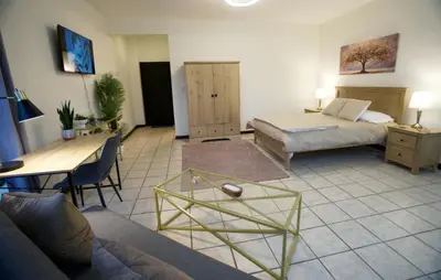 a living room with two beds and a table at Galeon House in San Rafael