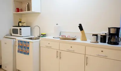 a kitchen with a sink and a microwave at Galeon House in San Rafael