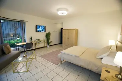 a bedroom with a bed and a desk and a couch at Galeon House in San Rafael