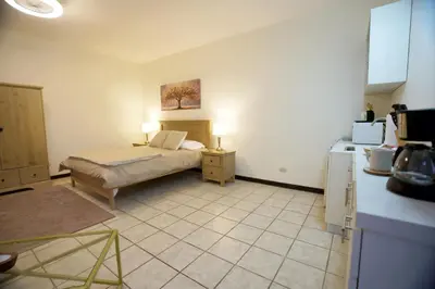 a small bedroom with a bed and a refrigerator at Galeon House in San Rafael