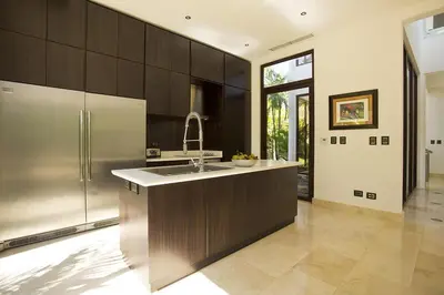 a kitchen with a sink and a refrigerator at Villa Cala Honda, Private Beachfront Escape in Santa Cruz