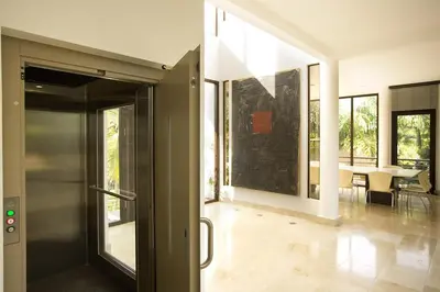 an open door to a living room with a table at Villa Cala Honda, Private Beachfront Escape in Santa Cruz