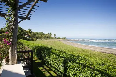 a path to the beach with a fence and the ocean at Villa Cala Honda, Private Beachfront Escape in Santa Cruz