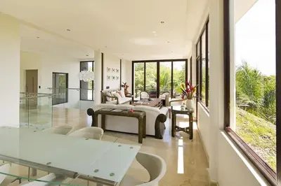 a living room with a couch and a table at Villa Cala Honda, Private Beachfront Escape in Santa Cruz