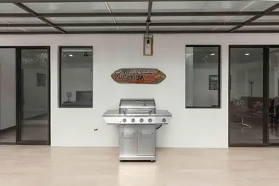 a kitchen with a stove and a sign on a wall at Casa Aurora with Private Patio & Pool in Coco