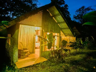 a small shed with a chair in front of it at Santa Maria Volcano Lodge Hotel & Restaurante in Hacienda Santa María