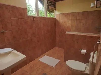 a bathroom with a toilet and a sink at Santa Maria Volcano Lodge Hotel & Restaurante in Hacienda Santa María
