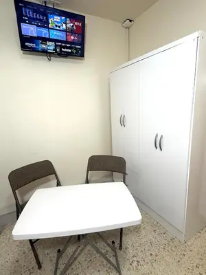 a white table and two chairs in a room with a tv at Beautiful loft in San José in San José