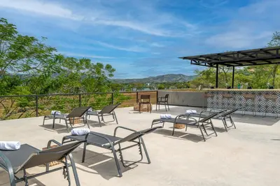 a group of chairs and tables on a patio at Nelblu Flamingo Suites in Playa Flamingo