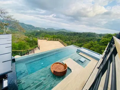 a swimming pool on the roof of a house with a view at Villa Cielo Sueños in Carrillo