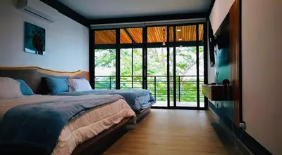 a bedroom with a bed and a large window at Villa Cielo Sueños in Carrillo