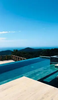 a swimming pool with a view of the ocean at Villa Cielo Sueños in Carrillo
