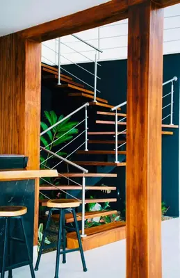a metal staircase in a room with stools at Villa Cielo Sueños in Carrillo
