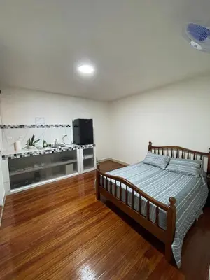 a bedroom with a bed and a flat screen tv at Mini-apartment located in the heart of San José in San José