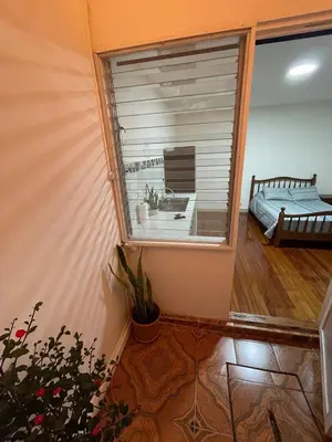 a room with a window and a bed in a room at Mini-apartment located in the heart of San José in San José
