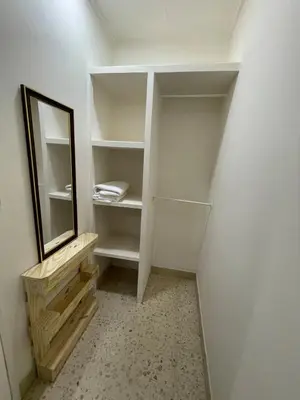 a walk in closet with a mirror and a staircase at Mini-apartment located in the heart of San José in San José