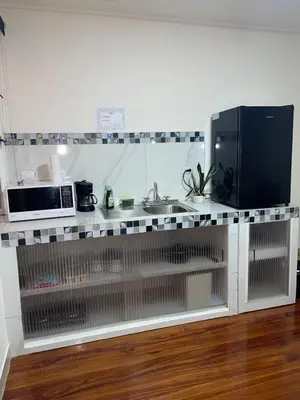 a kitchen counter with a sink and a microwave at Mini-apartment located in the heart of San José in San José