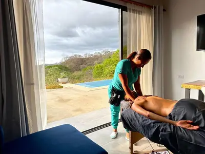 a woman giving a woman a massage in a room at Casa Coroico Infinity Pool BBQ Sunset Views in Santa Cruz