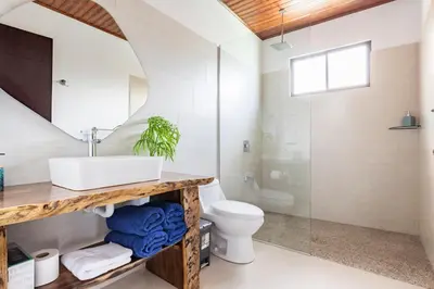 a bathroom with a sink and a toilet at Casa Coroico Infinity Pool BBQ Sunset Views in Santa Cruz