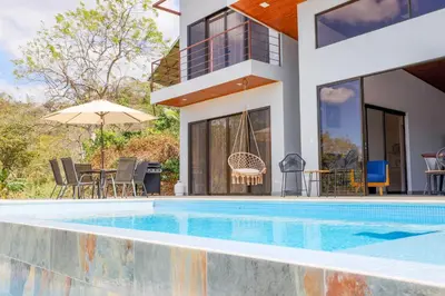 a villa with a swimming pool and a house at Casa Coroico Infinity Pool BBQ Sunset Views in Santa Cruz