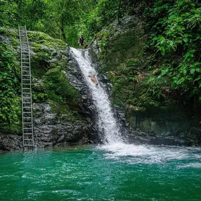 a person standing in front of a waterfall at New, Private River, Wifi, AC, King Bed, Jungle Shower in Ojochal