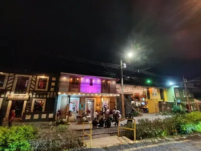 a group of people standing outside a building at night at Lovely comfy studio in the city, with AC in San José