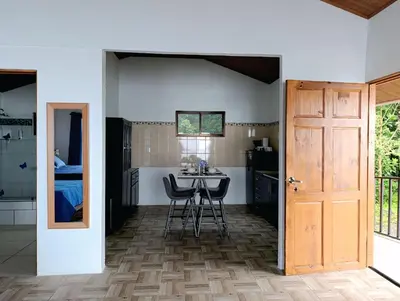 a room with a table and chairs and a door at Finca Alta Vista Monteverde in Monteverde Costa Rica