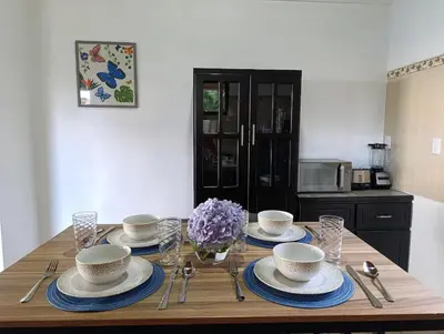 a wooden table with plates and bowls on top of it at Finca Alta Vista Monteverde in Monteverde Costa Rica