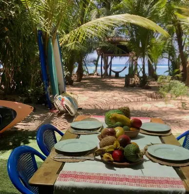 a picnic table with a plate of fruit on it at Paradise in Puntarenas