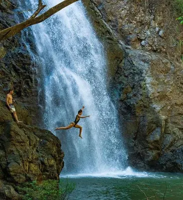 a person jumping off of a waterfall at Paradise in Puntarenas