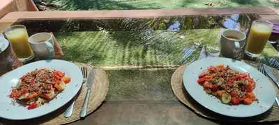 two plates of food on a table with drinks at Paradise in Puntarenas