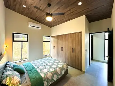 a bedroom with a bed and a ceiling fan at Eben-ezer #1 in Uvita