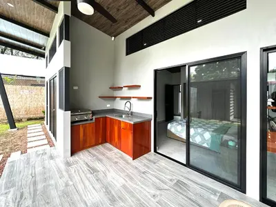 a kitchen with a sink and a bed in a room at Eben-ezer #1 in Uvita