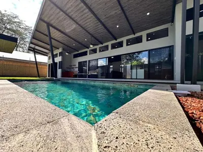 a swimming pool in front of a house at Eben-ezer #1 in Uvita