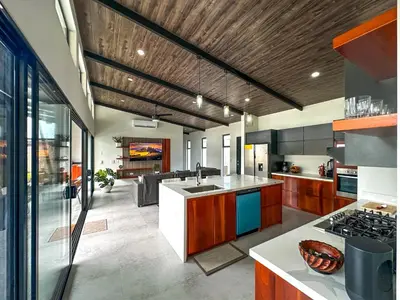 a large kitchen with a sink and a stove at Eben-ezer #1 in Uvita