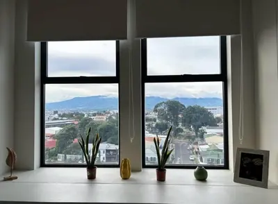 a room with three windows with plants on a table at Studio Apartment URBN Escalante in San José