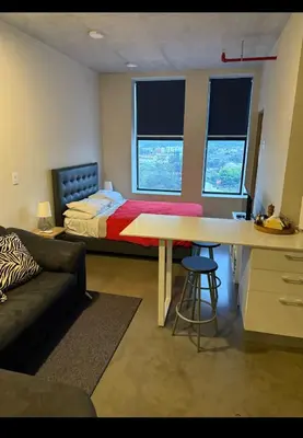 a bedroom with a bed and a desk with a table at Studio Apartment URBN Escalante in San José