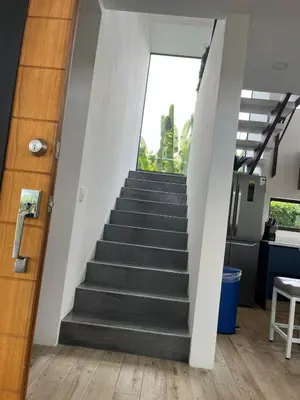 a staircase leading up to a building with a window at Casa Grande Pura Vida in Fortuna