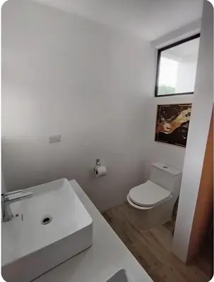 a bathroom with a white sink and a toilet at Casa Grande Pura Vida in Fortuna