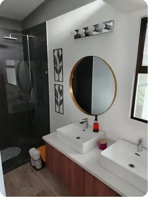 a bathroom with a sink and a mirror and a shower at Casa Grande Pura Vida in Fortuna