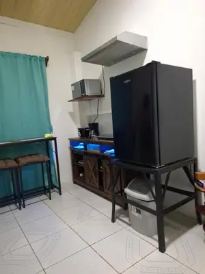 a large television on a table in a kitchen at Cabinas Kai in Quepos