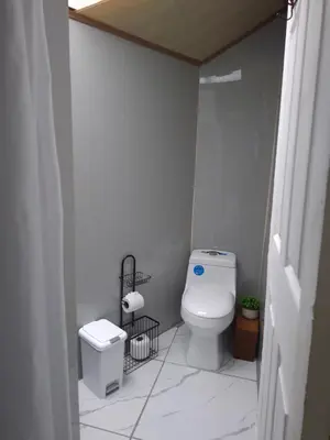 a small bathroom with a toilet and a sink at Cabinas Kai in Quepos