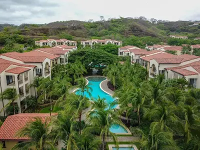 an aerial view of a resort with a pool and palm trees at Luxury Pacifico 3 Bedroom 2 Bath with 300 Mbps WI-FI in Coco