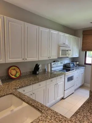 a kitchen with white cabinets and white appliances at Luxury Pacifico 3 Bedroom 2 Bath with 300 Mbps WI-FI in Coco