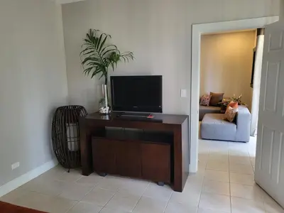 a living room with a flat screen tv on a table at Luxury Pacifico 3 Bedroom 2 Bath with 300 Mbps WI-FI in Coco