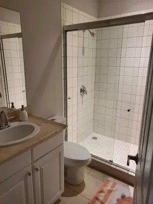 a bathroom with a shower and a toilet and a sink at Luxury Pacifico 3 Bedroom 2 Bath with 300 Mbps WI-FI in Coco
