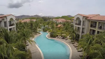 an aerial view of a swimming pool at a resort at Luxury Pacifico 3 Bedroom 2 Bath with 300 Mbps WI-FI in Coco